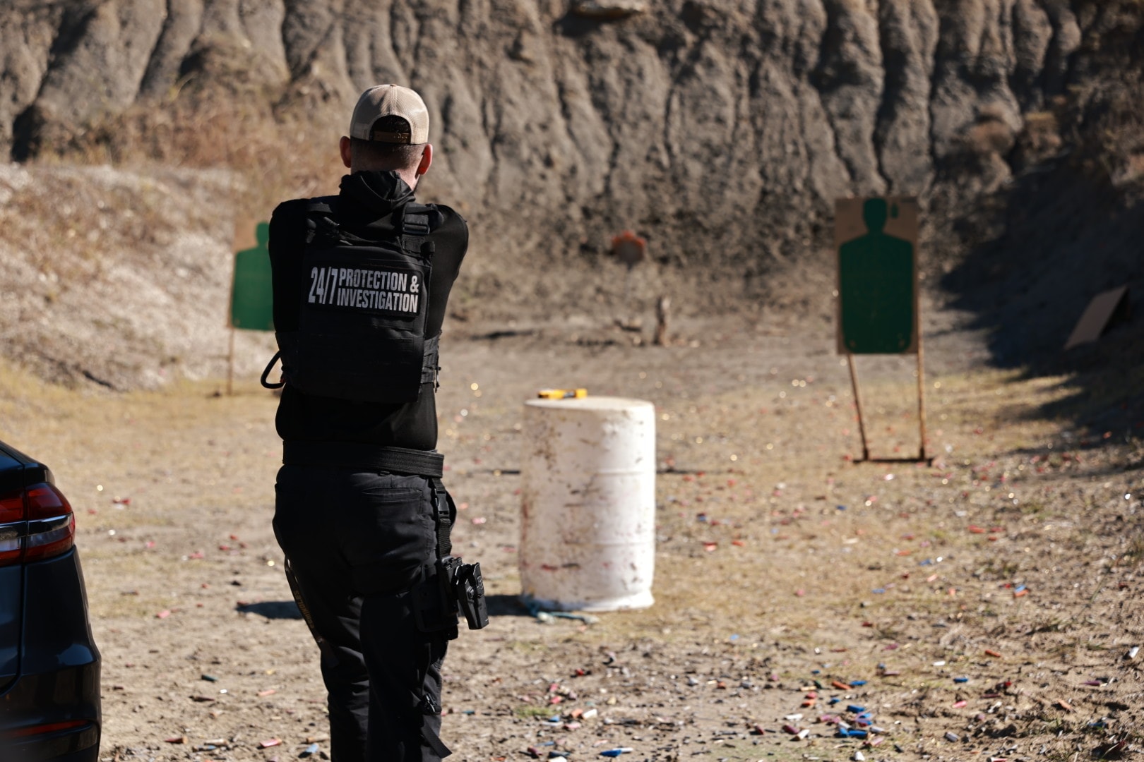 Security officer firing at target during range training