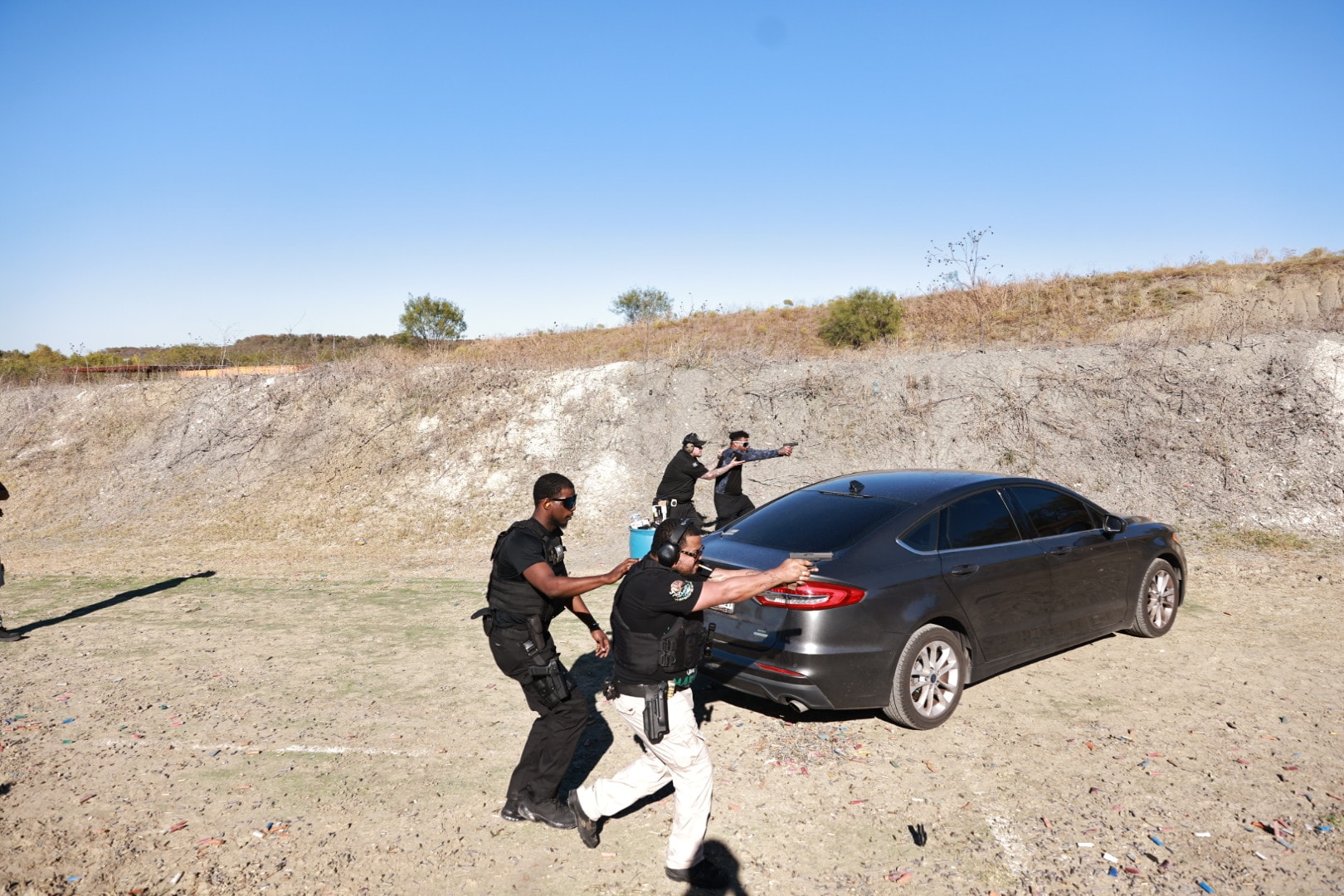 Group tactical drill with multiple officers and vehicle