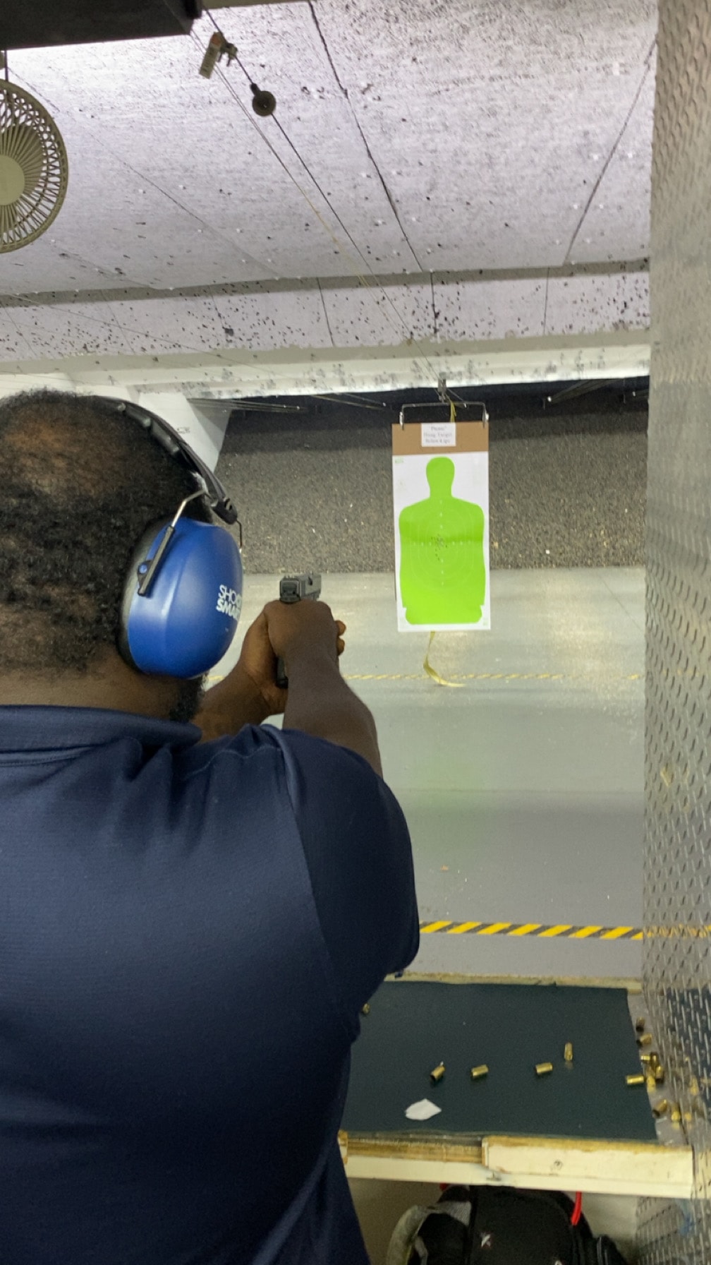 Trainee in shooting stance at indoor range