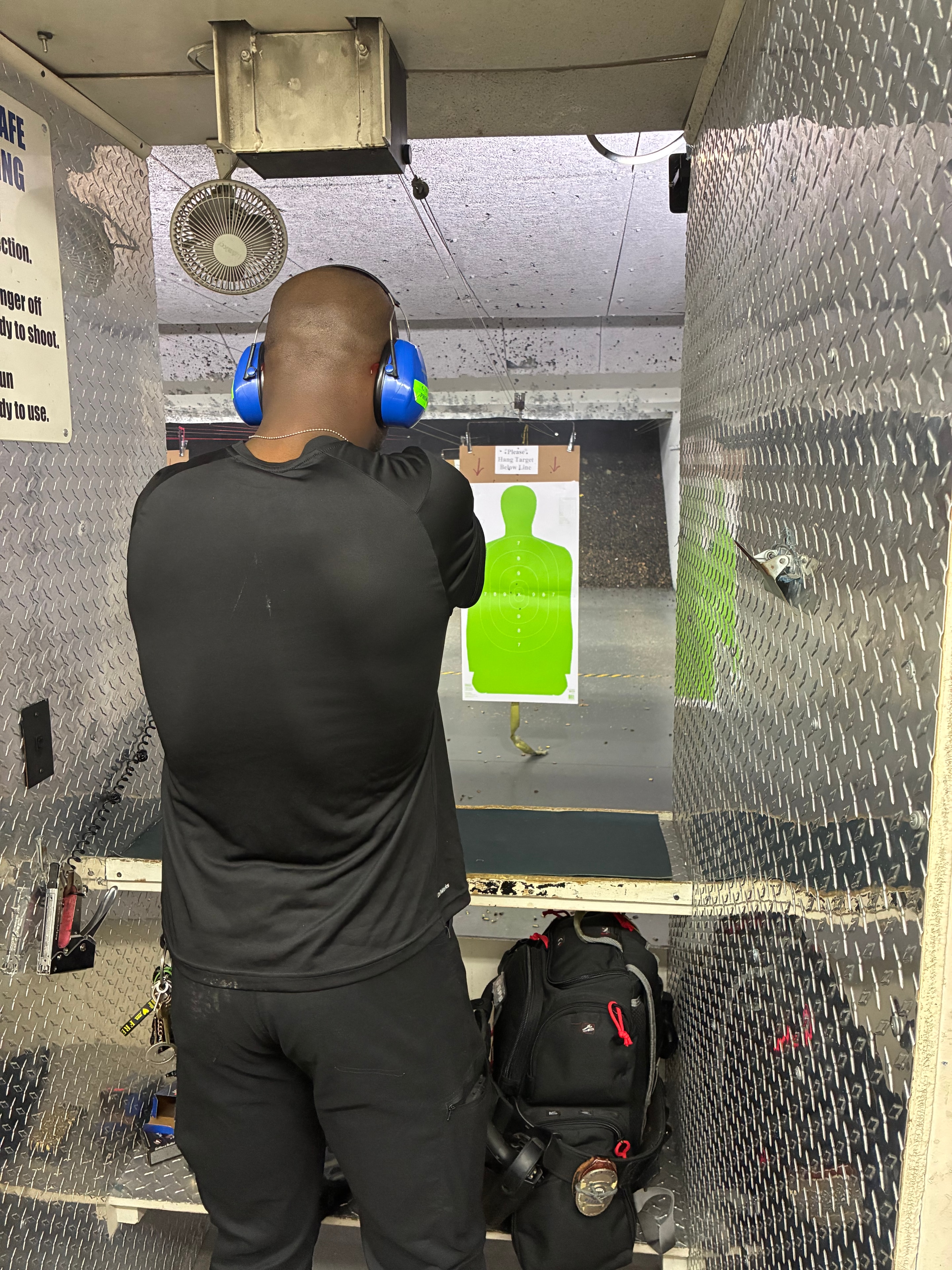 Level III candidate at firing line with green silhouette target
